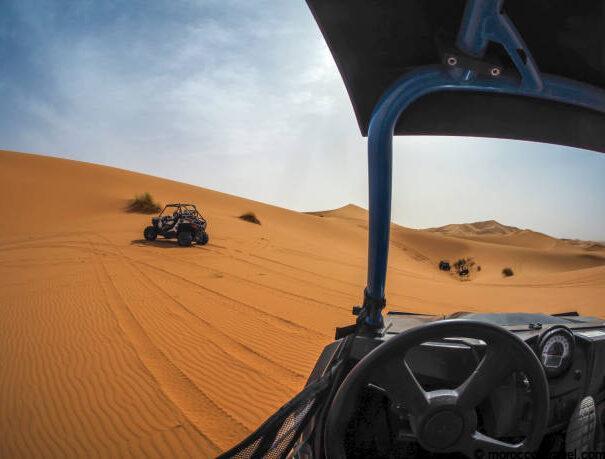 Dune Buggy Tous & Excursion In Merzouga Desert , Morocco Merzouga, Morocco. September 2019. 4*4 buggies driven through the sand dunes of the Sahara desert in Morocco on a hot morning.